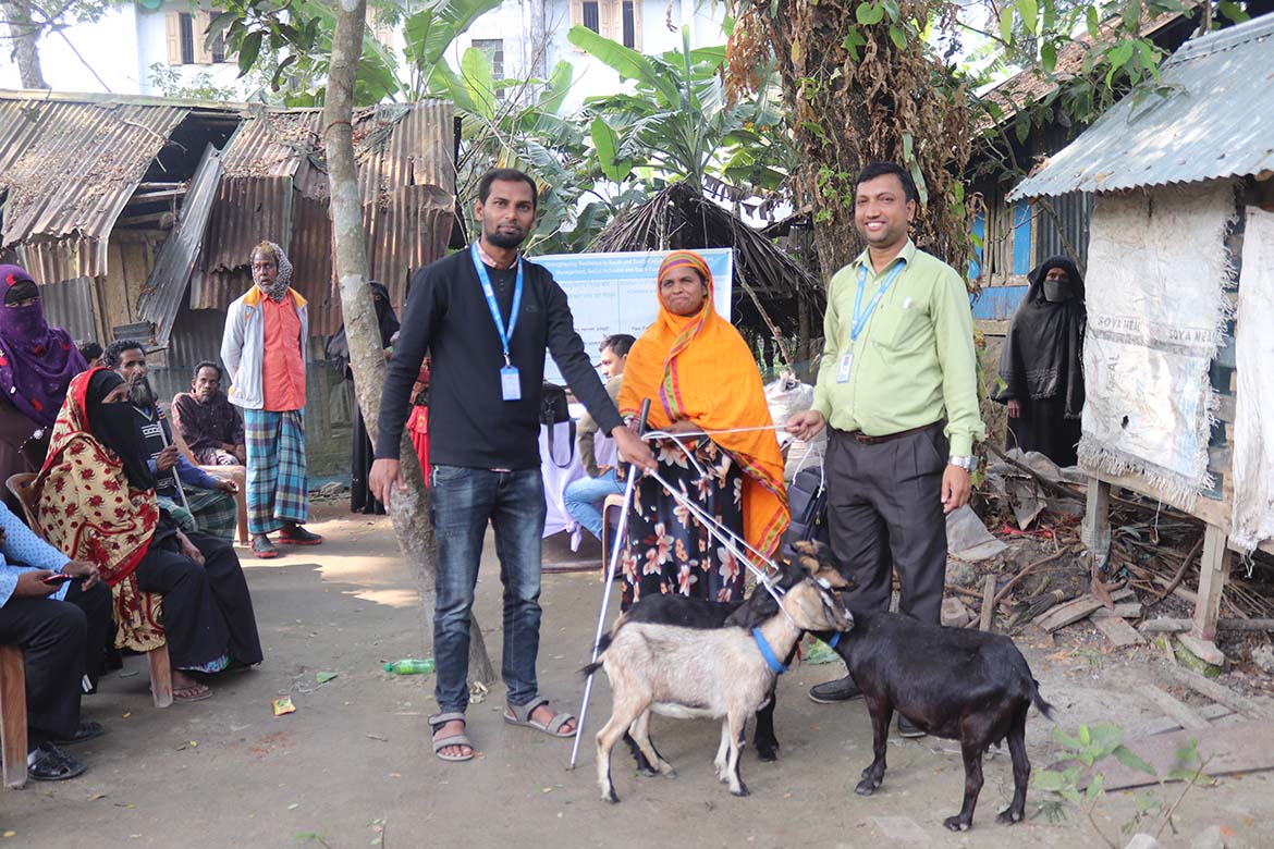 Khadija Begum a person with visula imparement is receiving livestock items from the project team.jpg