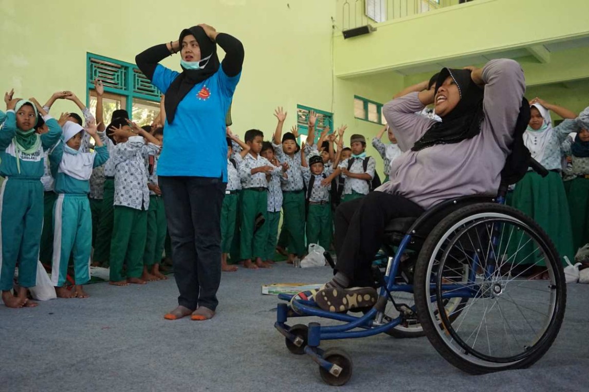 1.3. Dwi (on wheelchair) facilitate a session on disaster safety procedure in Ngablak Village, Magelang, Central Java, Indonesia 2018.jpg